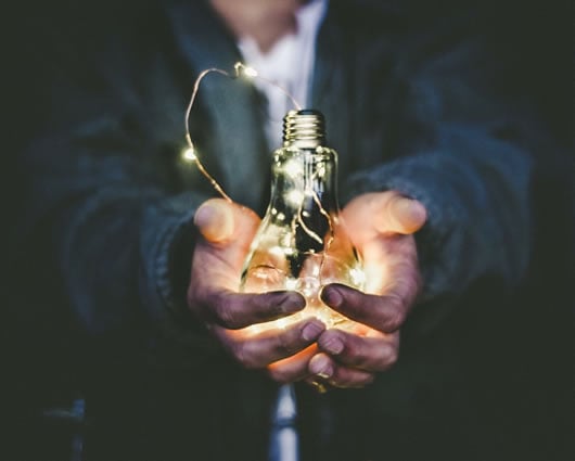 Inventor holding the lightbulb.